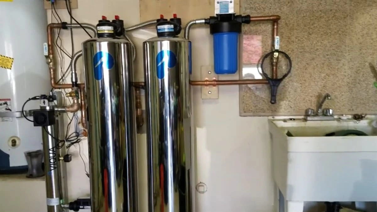 Water filtration system installation with dual stainless steel tanks, sediment filter, and copper piping in Clovis CA