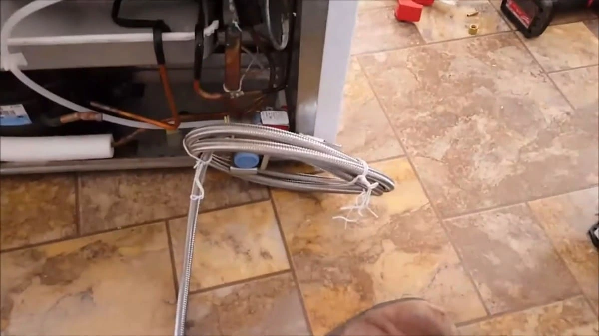 Kitchen appliance plumbing connections and braided supply line installation during residential kitchen plumbing service in Clovis CA