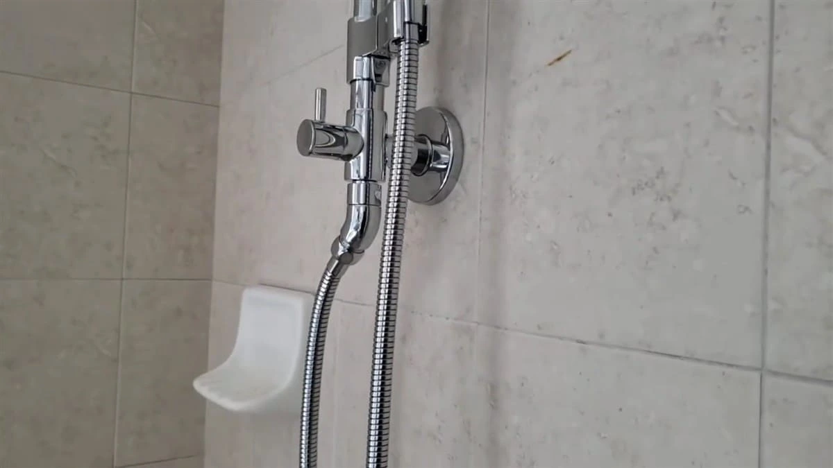 Luxury bathroom fixture plumbing installation completed in Clovis CA featuring a premium handheld shower fixture and custom tile surround